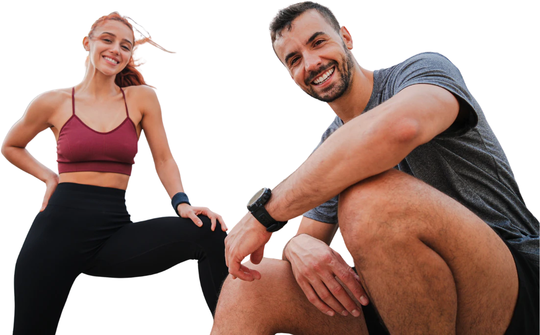 Smiling couple in workout clothes, the man crouching beside her
